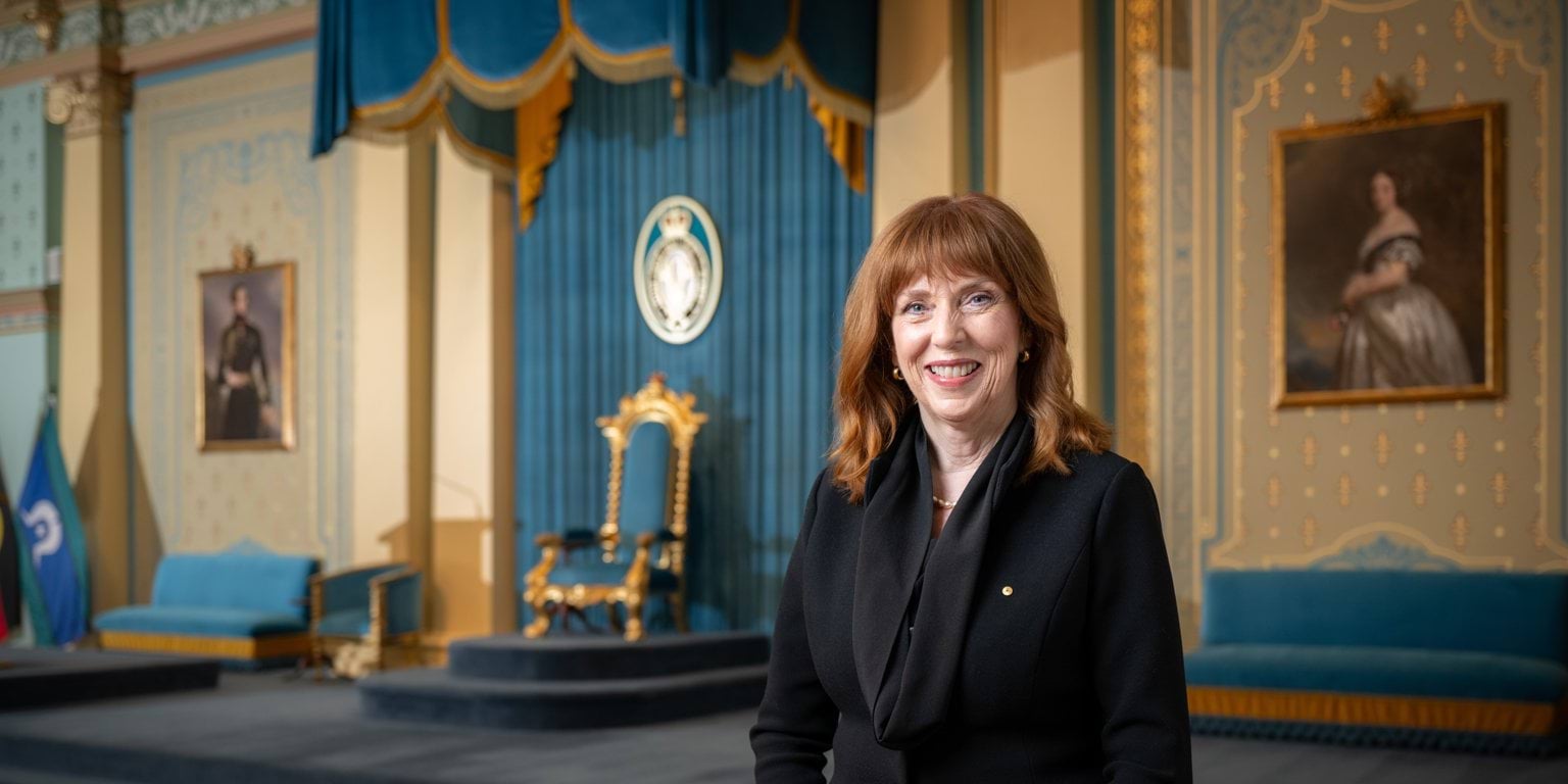 Her Excellency Professor the Honourable Margaret Gardner AC standing in front of the State Chair in the ballroom at Government House.