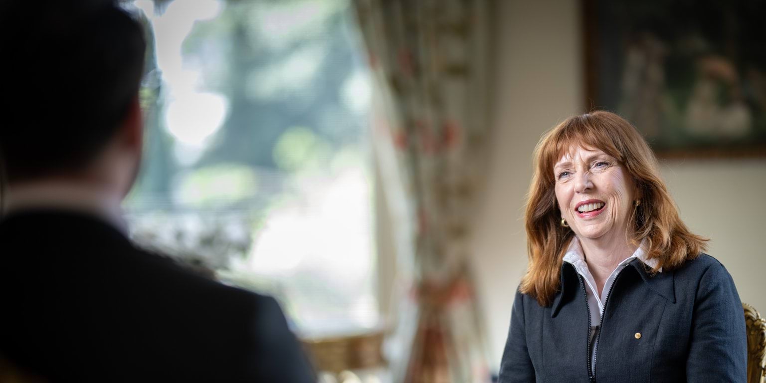 Her Excellency Professor the Honourable Margaret Gardner AC seated and smiling during a meeting