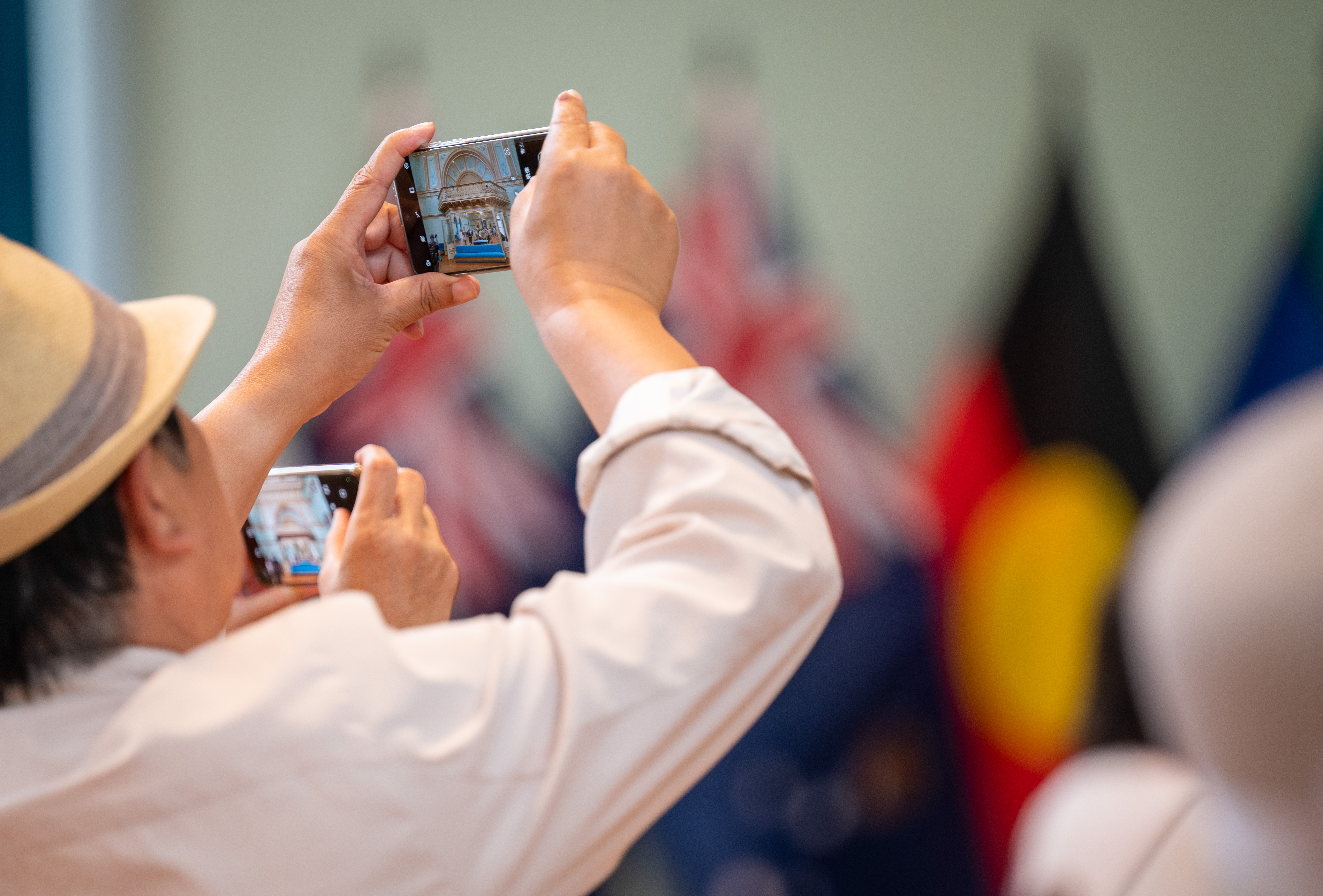 A visitor at a Government House Victoria Open Day taking a photo in the ballroom