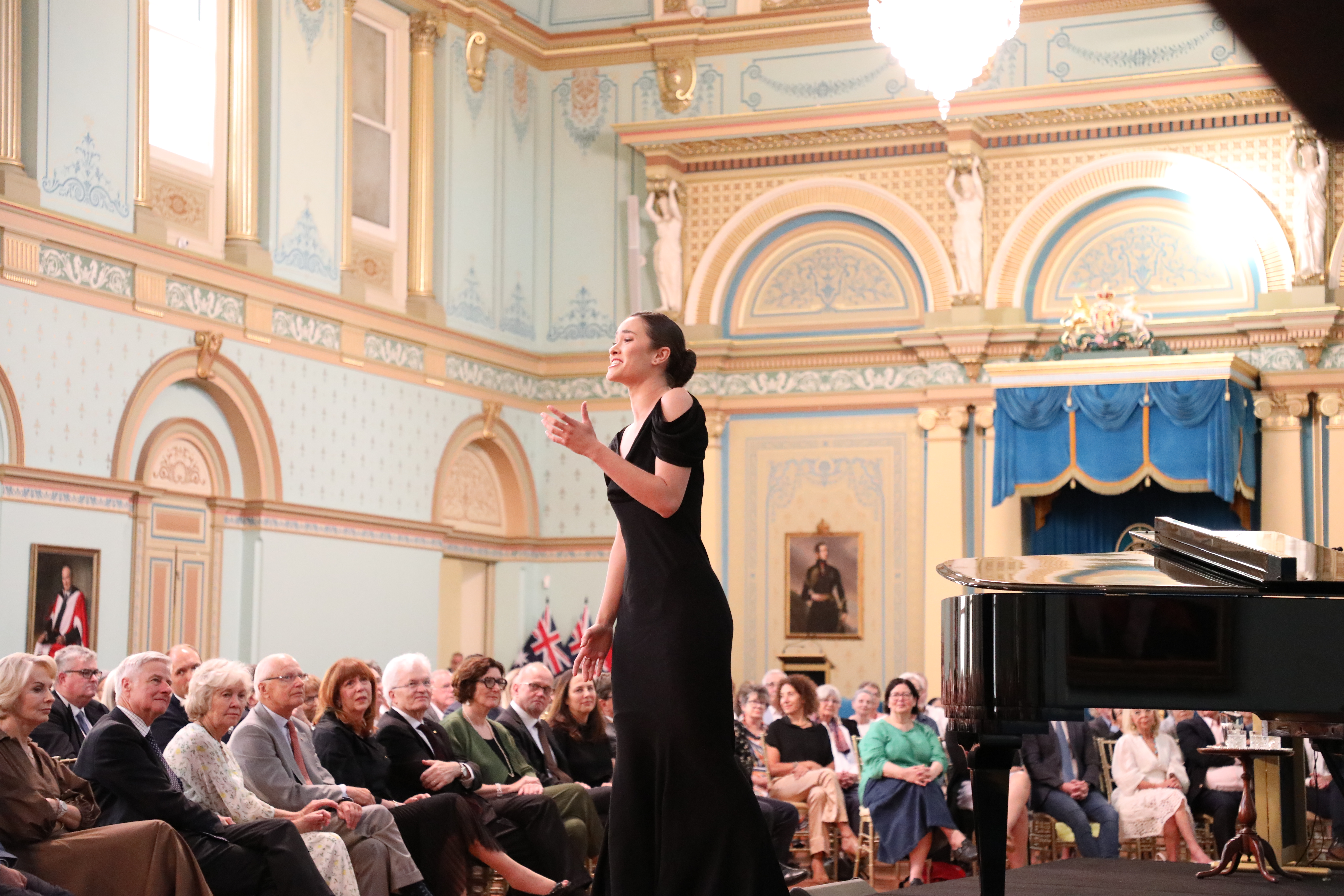An opera singer performing in the ballroom at Government House Victoria.